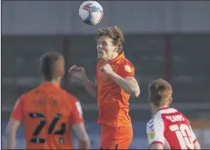  ??  ?? ROCK SOLID Sean Raggett wins a header against Fleetwood