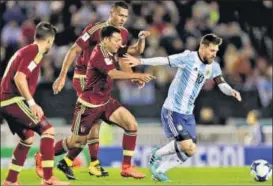  ?? AP ?? Surrounded by Venezuela players, Argentina’s Lionel Messi controls the ball during their qualifier in Buenos Aires on Tuesday.