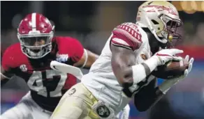  ?? THE ASSOCIATED PRESS ?? Alabama linebacker Christian Miller, left, defends Florida State running back Jacques Patrick during Saturday’s game in Atlanta. Miller later sustained a season-ending biceps injury.