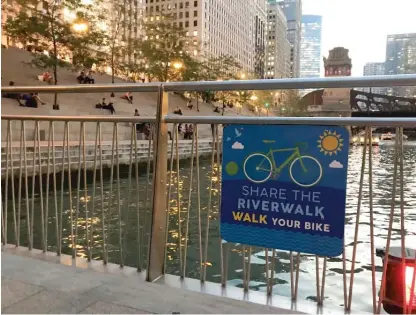  ?? SUN-TIMES PHOTO ?? According to Ald. Brendan Reilly, a ‘‘tremendous number’’ of cyclists are flocking to the Riverwalk and ignoring these signs.