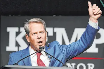  ?? John Bazemore The Associated Press ?? Republican Gov. Brian Kemp waves to supporters on Tuesday’s primary night.