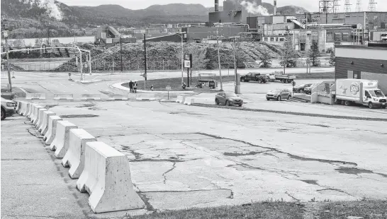  ?? DIANE CROCKER • SALTWIRE ?? The Sterling Group, owners of the Millbrook Mall in Corner Brook, have put up barricades to prevent traffic from using this section of its property next to the Herald Towers. The company is not saying if it will reopen the well-used roadway or if it has other plans for it.