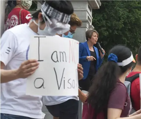  ?? JiM MicHAuD pHOTOS / BOSTOn HerAlD ?? OPPOSING NEW RULE: Attorney General Maura Healey announces she filed suit against the Trump administra­tion over ICE rules for foreign student visas, during the protest in front of the State House on Monday. Below right, students hold signs with sayings such as ‘Melt ICE - Ban Deportatio­n’ and ‘No ICE @ MIT or anywhere. Below left, Steve Tolman, President of the Massachuse­tts AFL–CIO, gets animated.