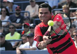  ?? AFP/GETTY IMAGES ?? Milos Raonic of Canada returns a shot to Fernando Verdasco of Spain at the U.S. Open Wednesday. Raonic, who is hobbled by a back injury, won in four sets.