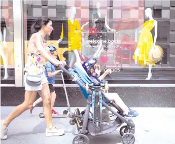  ?? — AFP photo ?? People walk in front of the recently opened Bloomingda­le’s store as Manhattan enters Phase 2 of re-opening following restrictio­ns imposed to curb the coronaviru­s pandemic in New York City.