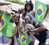  ?? LIONEL ROOKWOOD PHOTOS ?? Brazil supporters celebrate their team’s win on Sixth Street.