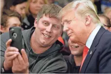  ?? WILLIAM GLASHEEN, USA TODAY NETWORK ?? Mike Morill takes a selfie with Republican presidenti­al candidate Donald Trump during a rally Wednesday in Appleton, Wis.