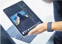  ?? BEBETO MATTHEWS/ASSOCIATED PRESS ?? An iPad Pro is reviewed after an event in Brooklyn on Tuesday where Apple unveiled the latest iPads and Macs.