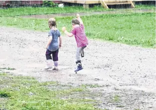  ??  ?? Did you ever dance in the rain? Thea and Elena Ingraham were spotted doing just that one-day last month in their yard in Cheticamp, N.S. Mom, Ashely, was close by admiring the girls’ unbridled joy. Chance of giggles – 100 per cent.