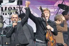  ?? Mike Coppola
Getty Images ?? RINGO STARR,
left, teamed with old Beatles band mate Paul McCartney.