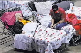  ?? Curtis Compton ?? The Associated Press file Thomas Lairsey, 71, and his wife Ann, 67, move into the Red Cross shelter at the Albany Civic Center to ride out Hurricane Irma on Sunday in Albany, Ga. After confrontin­g back-to-back major hurricanes, the American Red Cross...