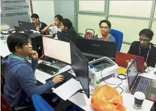  ??  ?? IT wizards: Adrian (left) with some of the other support staff hard at work during the recent SEA Games.