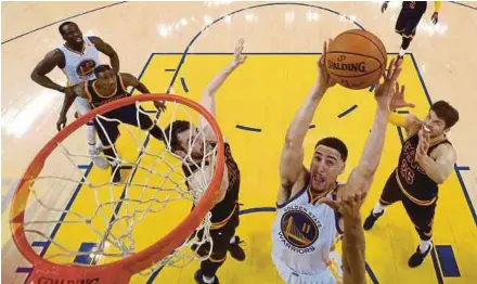  ??  ?? Klay Thompson of the Golden State Warriors goes up for a shot against the Cleveland Cavaliers in Game 1 of the NBA Finals on Thursday.