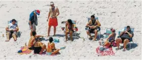  ?? THE ASSOCIATED PRESS ?? New Jersey Gov. Chris Christie, right, uses the beach Sunday with his family and friends at the governor’s summer house at Island Beach State Park. Christie is defending his use of the beach, which was closed to the public during New Jersey’s...