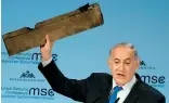  ??  ?? Israeli Prime Minister Benjamin Netanyahu with an object he claimed was a piece of Iranian drone shot down in Israeli airspace. — AFP