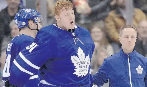  ?? FRANK GUNN / THE CANADIAN PRESS ?? Leafs goalie Frederik Andersen is helped off the ice after being hit under his mask by Corey Perry’s skate Monday.