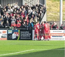  ?? ?? The players and the fans celebrate after Burton scores the winner