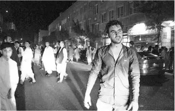  ??  ?? People react on the street, following a suicide bomb attack at the mosque in Herat. — AFP photo