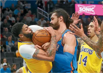  ?? AP ?? Lakers forward Anthony Davis, left, gets up close and personal with Thunder centre Steven Adams.