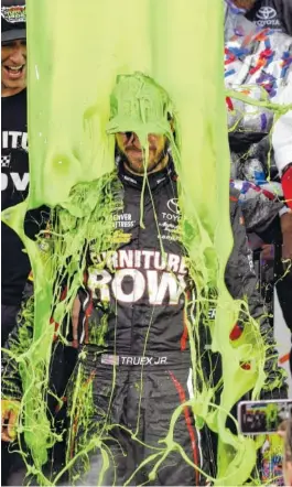  ?? THE ASSOCIATED PRESS ?? Martin Truex Jr. celebrates with his crew after winning a race on Sept. 17 at Chicagolan­d Speedway in Joliet, Ill. Truex won the pole Friday for Sunday’s race at Dover Internatio­nal Speedway.