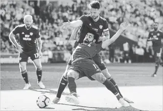  ?? MIKE HEWITT GETTY IMAGES ?? Mohamed Salah of Liverpool wins a penalty after being fouled by Sean Morrison of Cardiff City on Sunday.