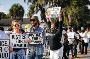  ?? Nicole Craine / New York Times ?? Protesters gather outside the courthouse in Brunswick, Ga. Many observers say Ahmaud Arbery’s death is a prominent example of racial violence, but prosecutor­s have avoided that characteri­zation.