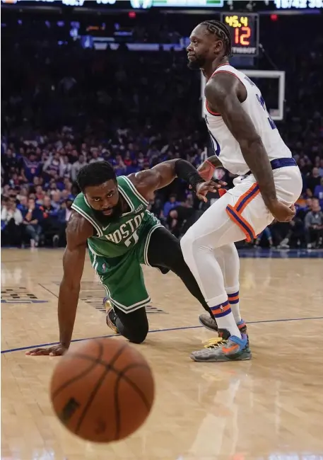  ?? Ap ?? GOT AWAY FROM THEM: Jaylen Brown, left, reacts after losing control of the ball as New York’s Julius Randle defends him during the second half Wednesday in New York.