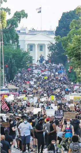  ??  ?? People protest over the death of George Floyd on 16th Street in Washington on Saturday, with the White House in the background.