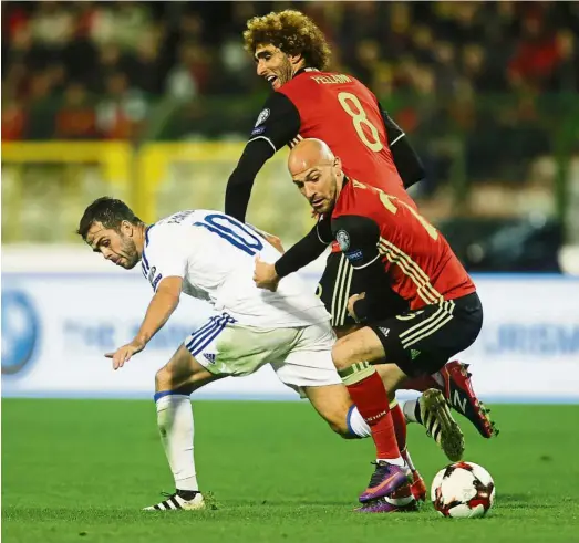  ??  ?? Getting aggressive: Belgium’s Laurent Ciman (right) vying for the ball with Bosnia’s Miralem Pjanic during the World Cup qualifying match at the King Baudouin Stadium in Brussels on Friday. Belgium won 4-0. — EPA