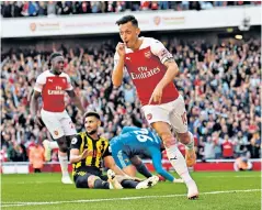  ??  ?? Sealed it: Mesut Ozil celebrates after scoring Arsenal’s second goal yesterday