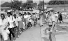  ?? Photograph: Jack Thornell/AP ?? Neshoba county deputy sheriff Cecil Price watches marchers as they pass through Philadelph­ia, Mississipp­i, during a memorial in June 1965 for three Freedom Summer activists killed by Klansmen in 1964.