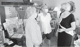  ?? SUSAN STOCKER/SOUTH FLORIDA SUN SENTINEL PHOTOS ?? Karen Porter and Sandy Kristoff talk about the late Supreme Court Justice Ruth Bader Ginsburg with Candy Johnson, owner of Cactus Flower, a gift shop in Fort Lauderdale.