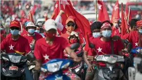  ?? — AFP ?? Red riders: NLD supporters taking part in an election campaign rally on the outskirts of Yangon.