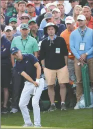  ?? The Associated Press ?? BACK ON COURSE: Jordan Spieth chips from the gallery to the 18th green during the first round at the Masters Thursday in Augusta, Ga. Spieth held a two-stroke lead at the end of the first round, the eighth time to lead after the first round in his past...