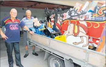  ?? Photo / Colin Thorsen ?? Pakeke Lions’ Ray Jackson (left) and Ian Grey help pack the sleigh chock-full of goodies ready to raffle off.