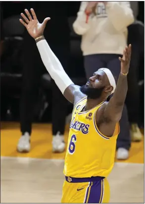  ?? (AP/Marcio Jose Sanchez) ?? LeBron James of the Los Angeles Lakers reacts after scoring the basket that made him the NBA’s all-time leading scorer Tuesday night in Los Angeles. James now has 38,390 career points and was not born when Kareem Abdul-Jabbar previously set the career mark in 1984.