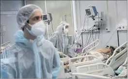  ?? ROMAN YAROVITCYN — THE ASSOCIATED PRESS ?? Medical staff treat a COVID-19 patient at an ICU in Infectious Hospital No. 23 in Nizhny Novgorod, Russia, on Wednesday.