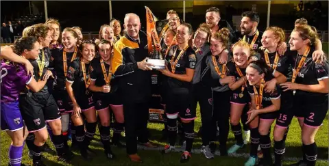  ??  ?? Wexford Youths captain Kylie Murphy is presented with the trophy by Tom Dennigan of Continenta­l Tyres.