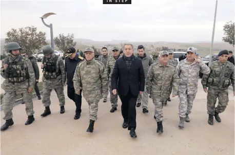  ?? AP African News Agency (ANA) ?? IN STEP TURKEY’S Defence Minister Hulusi Akar, centre, and army commanders visit troops in Kilis on Syria’s border. Russian and Turkish ministers met in Moscow to discuss northern Syria as US forces prepared to withdraw and Turkey threatened to launch a military operation against Us-backed Kurdish forces which controlled nearly a third of the country. |