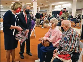  ?? BILL LACKEY / STAFF ?? Gov. Mike DeWine and his wife, Fran, talk with Thomas Whitaker and his wife, Judy, as they wait the required 15 minutes after getting their second COVID vaccine shot Thursday.