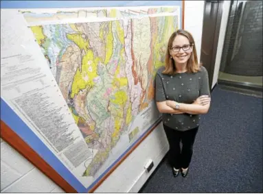  ?? ARNOLD GOLD / HEARST CONNECTICU­T MEDIA ?? Geology and geophysics professor Maureen Long is photograph­ed with a geological map of Connecticu­t at Yale University’s Kline Geology Laboratory in New Haven.