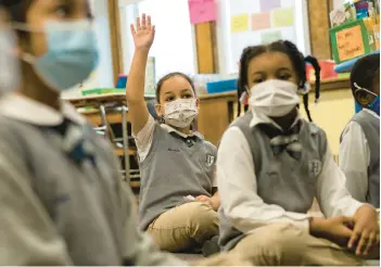  ?? CHRISTOPHE­R CAPOZZIELL­O/THE NEW YORK TIMES ?? A study reveals a link between mask mandates and COVID-19 in schools.