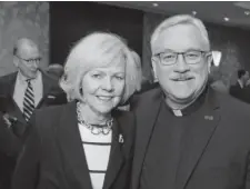  ??  ?? Mary Jo Boryla and Father John Fitzgibbon­s, Regis University president.