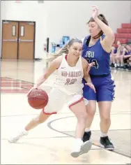  ?? Photo submitted ?? Mid-America Christian’s McKenzi Lamer drives to the basket past John Brown University forward Tarrah Stephens during Thursday’s game in Oklahoma City. MidAmerica Christian defeated John Brown 88-71 in the Golden Eagles’ 2021 season opener.