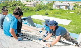  ?? Picture: LOGOS HOPE ?? HELPING HAND: A team from the Logos Hope helps fix homes in Barbuda damaged by Hurricane Irma