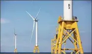  ?? Michael Dwyer / Associated Press ?? Offshore wind turbines near Block Island, R.I. One of two major climate bills signed by Gov. Ned Lamont this week aims to supply all of the state’s power from clean energy sources such as offshore wind by the year 2040.