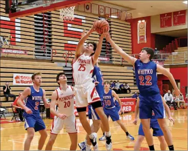  ?? PILOT PHOTO/MAGGIE NIXON ?? Easton Strain goes to the basket for Plymouth as teammate Owen Yoder looks on with Whitko defenders Brett Sickafoose and Dale Reiff. Strain draws the foul from Whitko’s Mason Streby.