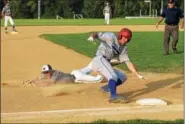 ?? AUSTIN HERTZOG - DIGITAL FIRST MEDIA ?? Boyertown’s Mike Xanthopoul­os, right, reaches third base after being tagged out by a diving Leif Wergeland during their game Tuesday.
