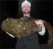  ??  ?? A flathead catfish caught in the Schuylkill River by Jonathan Pierce of Philadelph­ia set a new state record at 56.3 pounds.