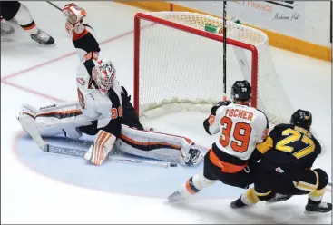  ?? NEWS FILE PHOTO RYAN MCCRACKEN ?? Medicine Hat Tigers goaltender Michael Bullion makes a toe save on Brandon Wheat Kings forward Reid Duke during a Western Hockey League game at the Canalta Centre on Feb. 25. Bullion will start in goal for Friday’s season opener in Lethbridge against...